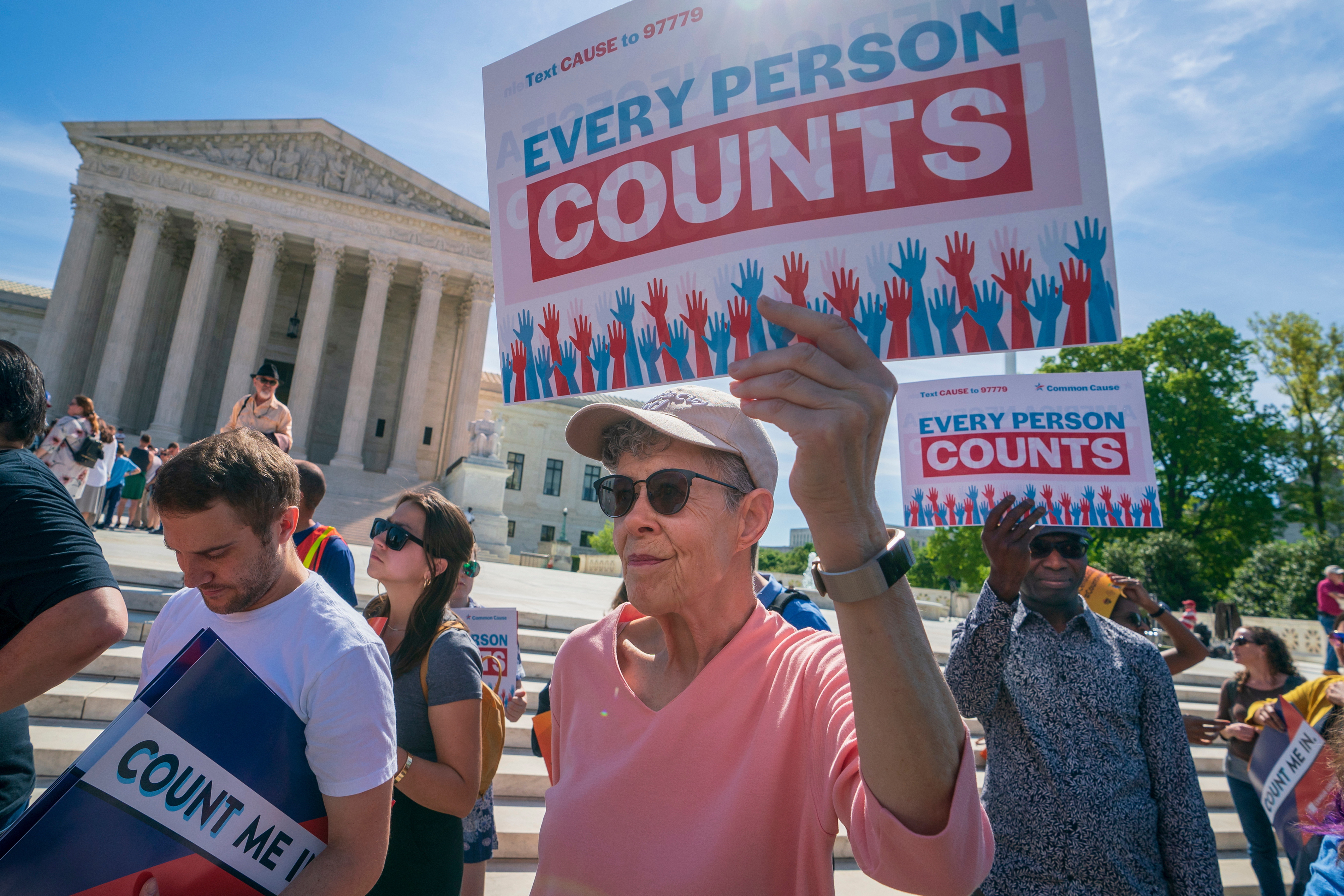Demonstrators holding signs saying "EVERY PERSON COUNTS" rally outside the Supreme Court in 2019 in Washington, D.C., as the justices hear arguments over the first Trump administration
